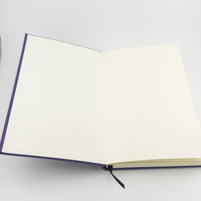 Journal opened to show blank inside covers and ribbon bookmark