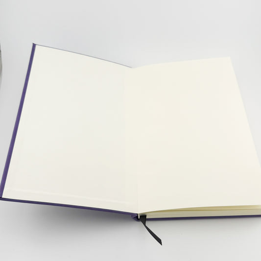 Journal opened to show blank inside covers and ribbon bookmark