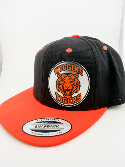 Wiggins Tigers black and orange snapback hat with silver patch, angled view
