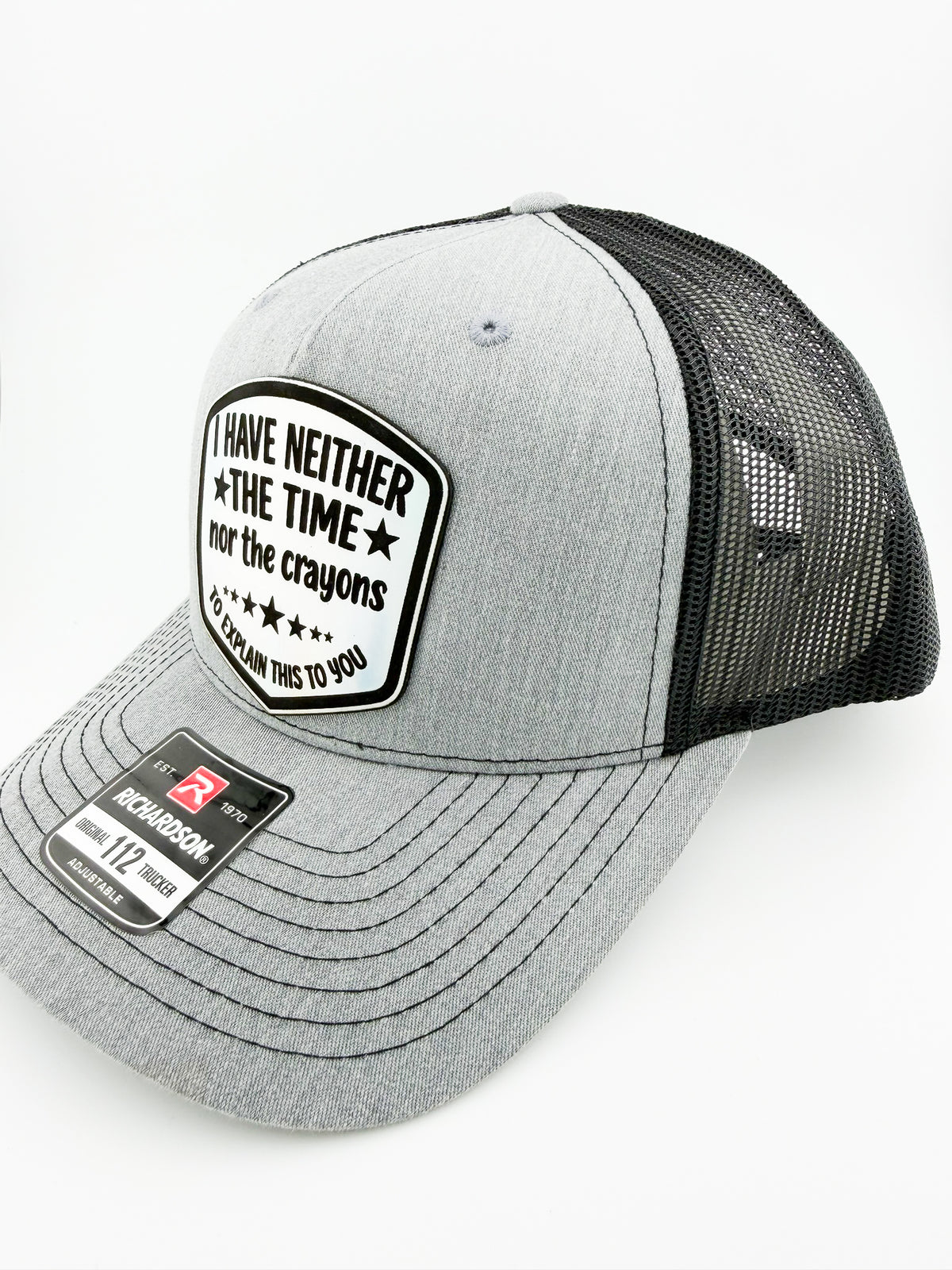 Neither the Time nor the Crayons patch on heather grey and black trucker hat, angled view